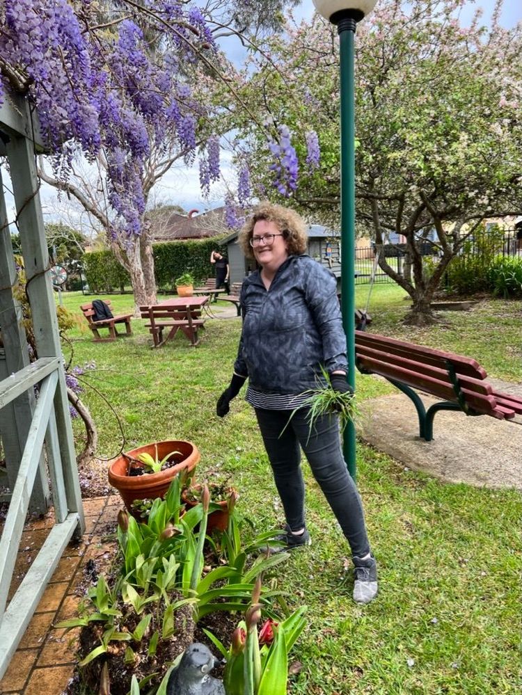 Nadine diligently weeding the grounds and beautifying the outdoor space.